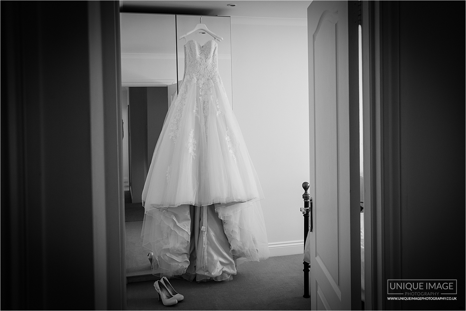 brides dress hanging with shoes