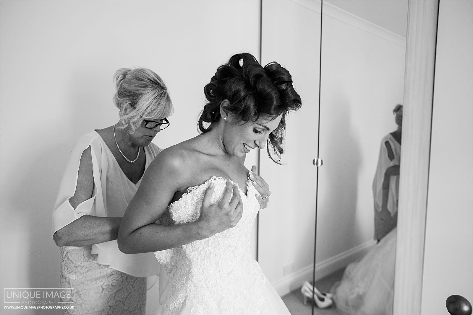 black and white of mum dressing bride