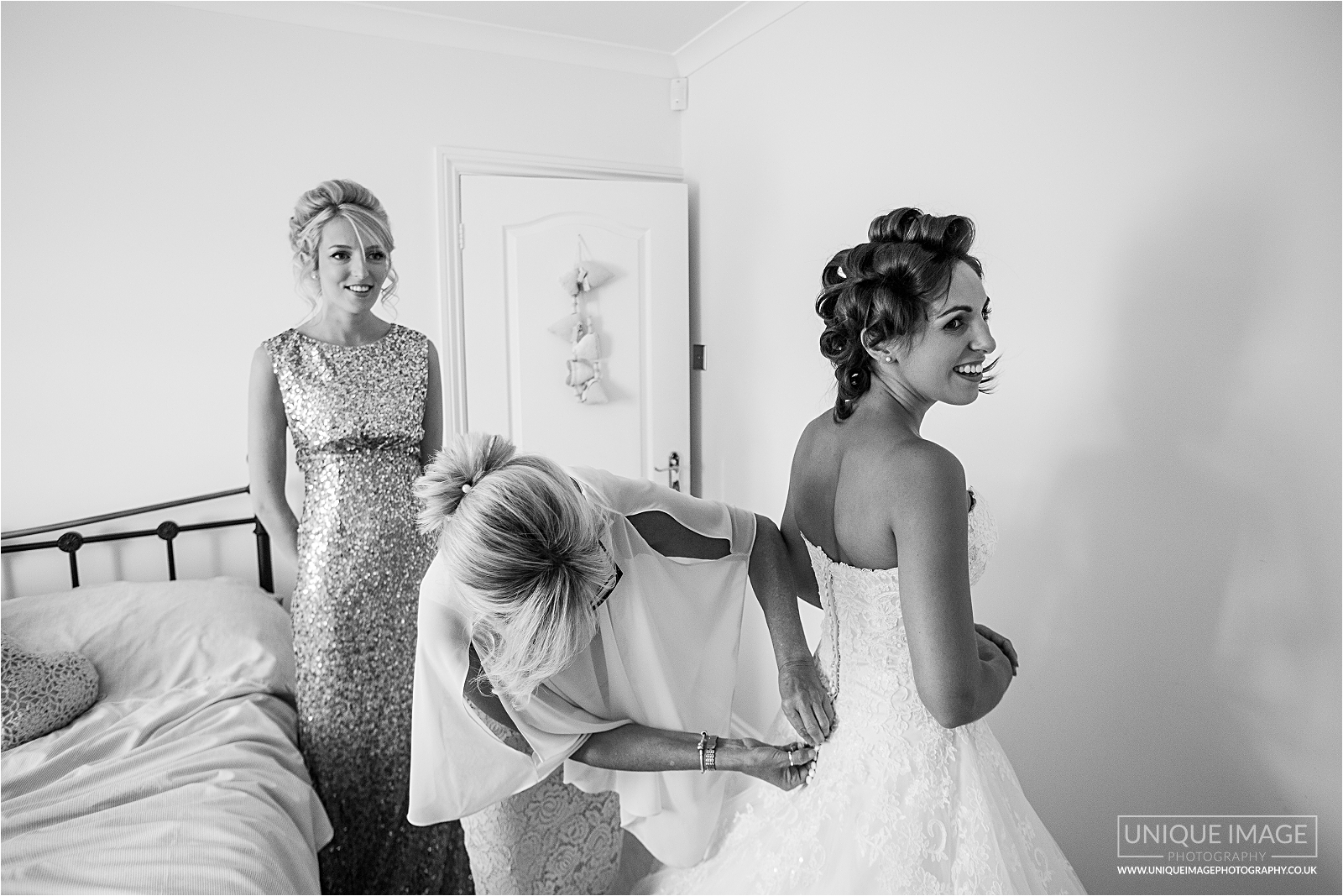 bride dressing with mum