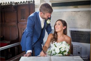 hapy couple signing the register