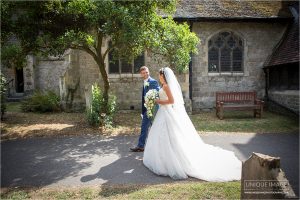 bride and groom walking through church